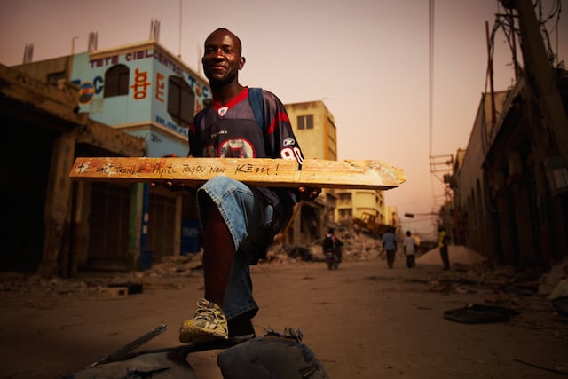 From Voices of Haiti. The sign reads "The Earth Can Shake But Haiti Remains In My Heart."