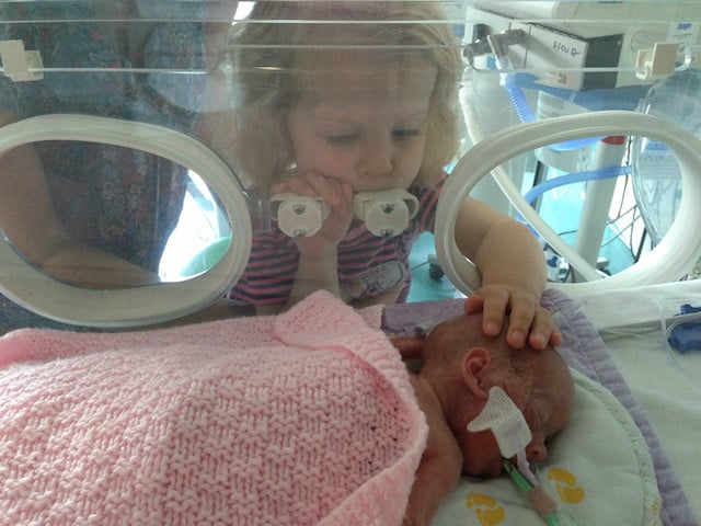 Day 27: Esme touching her little sister on the head. Edie looks relaxed and isn't bothered.