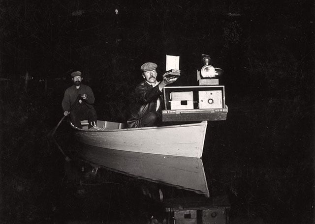 Shiras demonstrating his canoe camera and handheld flash on Whitefish Lake, Michigan.