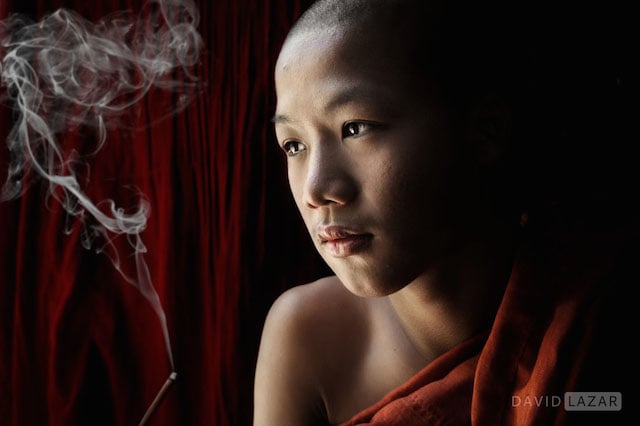 Monk looking out a window in Mandalay, Myanmar