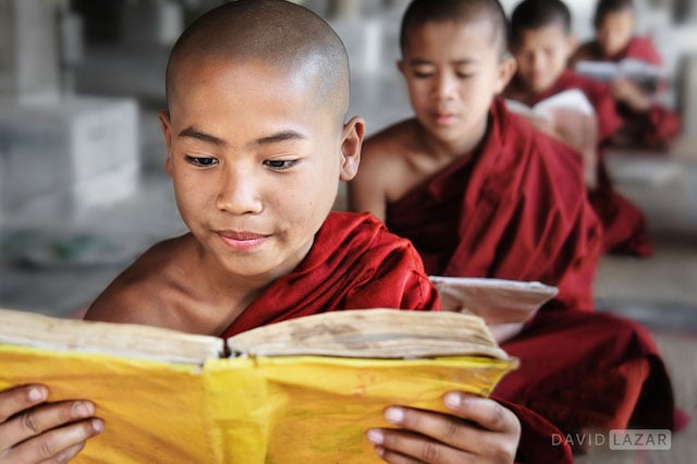 Novice monks in Inle Lake, Myanmar, creating a diagonal line in a repeated reading pose