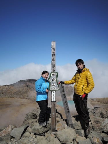 The last photo of the couple shows them posing at the summit of Mount