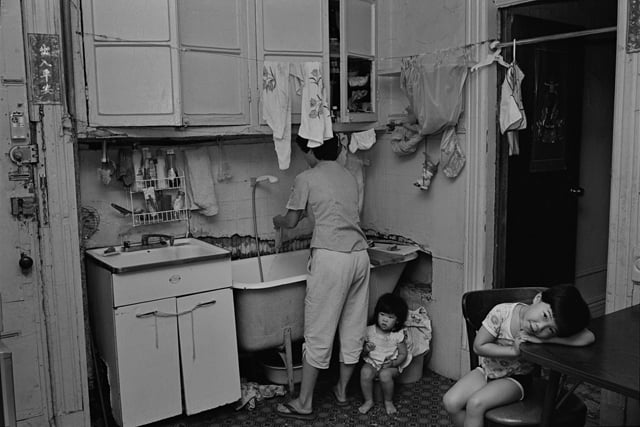 Rebecca with her children in their kitchen, 1982