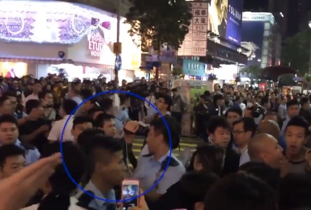 The moment the police officer turned around and hit his head on Wong's video camera.