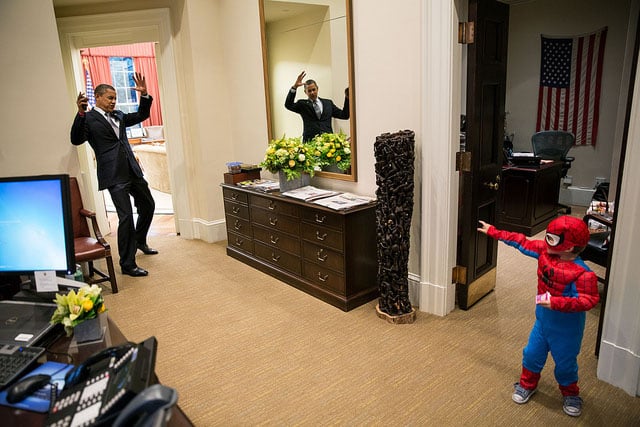 The President pretends to be caught in Spider-Man's web as he greets Nicholas Tamarin, 3, just outside the Oval Office. Spider-Man had been trick-or-treating for an early Halloween with his father, White House aide Nate Tamarin in the Eisenhower Executive Office Building. Oct. 26, 2012. [#]