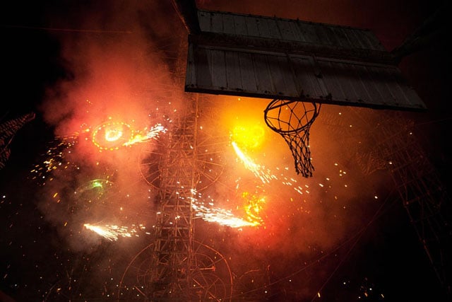 The firework castle explodes on the basketball court.