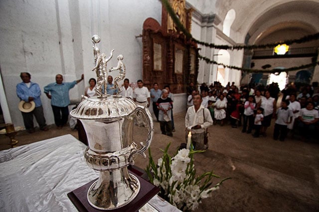 Villagers bless the first place basketball trophy in an early morning ceremony in San Cristobal Lachiroag. The trophy was valued at around $3,000.