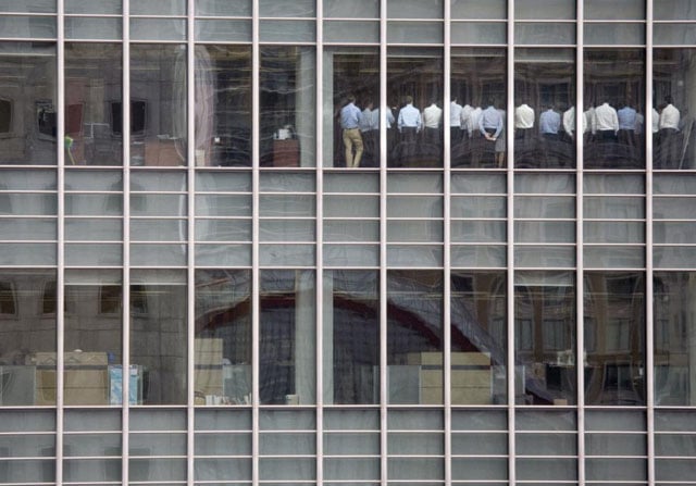 Staff members stand in a meeting room at Lehman Brothers offices in the financial district of Canary Wharf in London, September 11, 2008. Kevin Coombs.