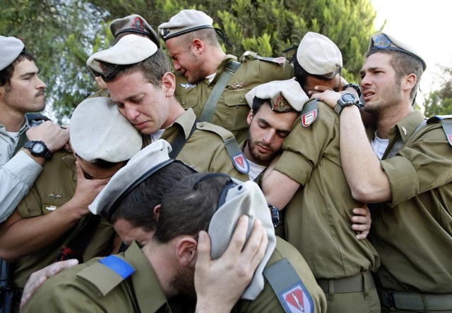 Israeli soldiers mourn during the funeral of their comrade Alex Mashavisky at a cemetery in Beersheba, Israel, January 7, 2009. Eric Gaillard.