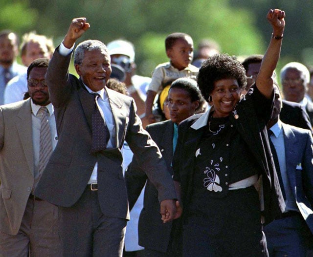 Nelson Mandela, accompanied by his wife Winnie, walks out of the Victor Verster prison near Cape Town after spending 27 years in apartheid jails, February 11, 1990. Ulli Michel.