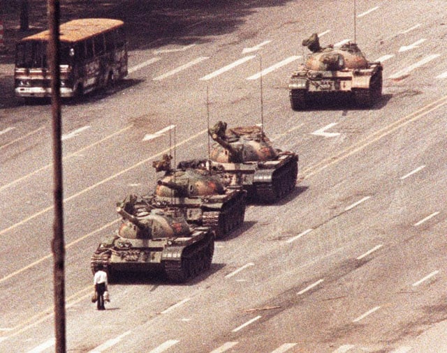 A man stands in front of a convoy of tanks in the Avenue of Eternal Peace in Tiananmen Square in Beijing, June 5, 1989. Arthur Tsang.
