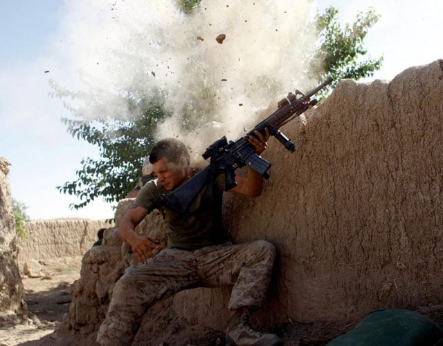 Sgt. William Olas Bee, a U.S. Marine from the 24th Marine Expeditionary Unit, has a close call after Taliban fighters opened fire near Garmser in Helmand Province of Afghanistan, May 18, 2008. Goran Tomasevic.