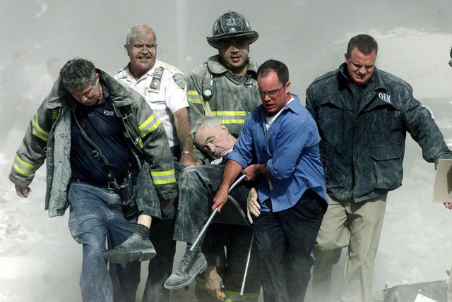 Rescue workers carry fatally injured New York City Fire Department Chaplain, Fether Mychal Judge, from one of the World Trade Center towers in New York, September 11, 2001. Shannon Stapleton.