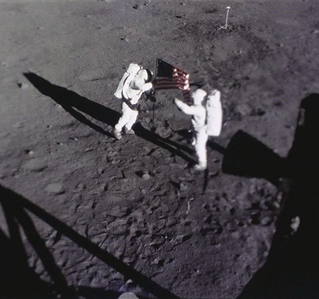 Neil Armstrong and Buzz Aldrin planting the flag of the United States on the moon.