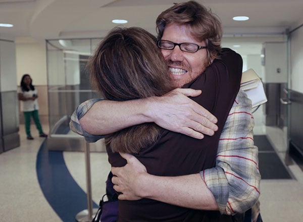 "Colleague Luisa Yanez, left, gives Jim Wyss, a welcome hug upon his arrival. Miami Herald reporter Jim Wyss arrived at Miami International Airport after being detained by Venezuela for three days on Sunday, November 10, 2013."