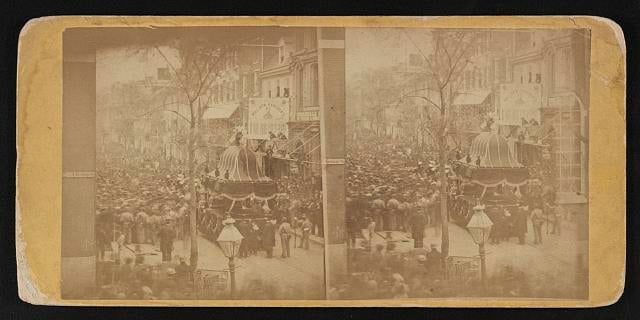  Photograph shows a procession following Abraham Lincoln's funeral car on the streets of Philadelphia, April 22, 1865.