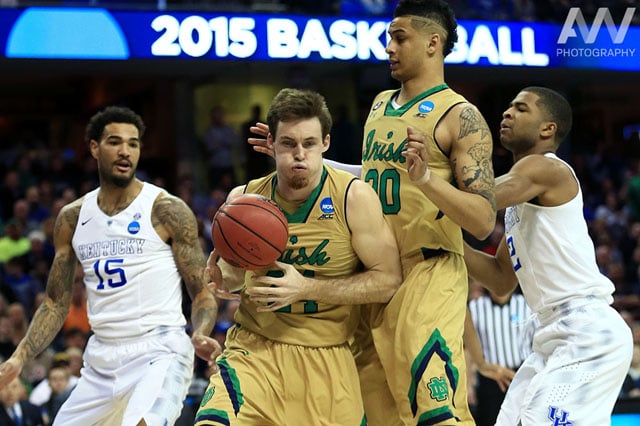 Notre Dame Fighting Irish guard/forward Pat Connaughton (24) works to control the ball ahead of Kentucky Wildcats forward Willie Cauley-Stein (15) and Notre Dame Fighting Irish forward Zach Auguste (30) during the first half in the finals of the midwest regional of the 2015 NCAA Tournament at Quicken Loans Arena.