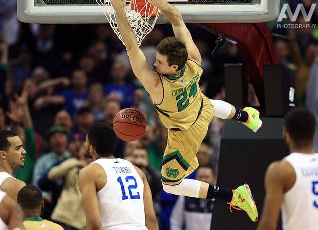 Notre Dame Fighting Irish guard/forward Pat Connaughton (24) dunks ahead of Kentucky Wildcats forward Karl-Anthony Towns (12) during the second half in the finals of the midwest regional of the 2015 NCAA Tournament at Quicken Loans Arena.