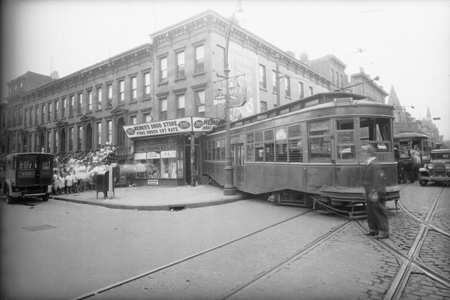 An accident in which a street car left its tracks and slammed into a store.