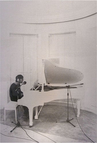 Peter Fordham's famous photo of John Lennon at his white grand piano.