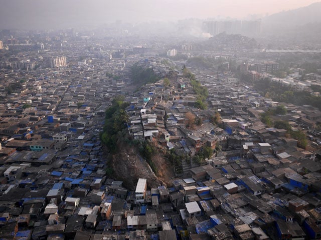 Morning over Maximum City. Known to the locals as "Hill 3" this knoll jutting above Mumbai's northern slums is no more valuable than the land below. Access to running water, which the hill lacks, is far more valuable than any view.