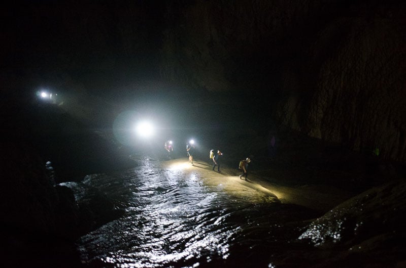 Part of the expedition team moving through the darkness of Son Doong. Photo by Sebastian Zethraeus