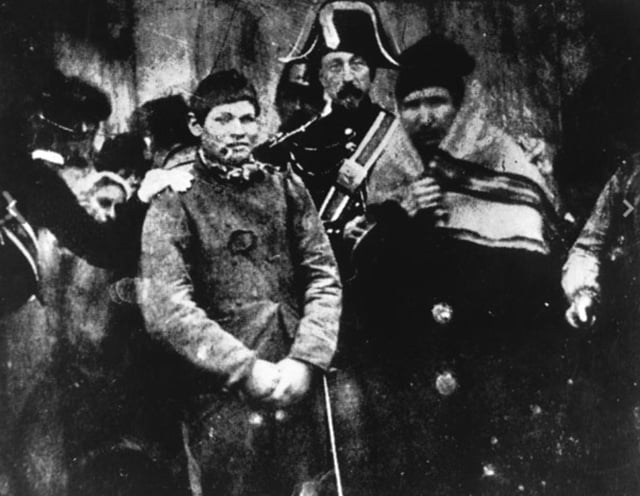 An old photo showing a man being arrested in France