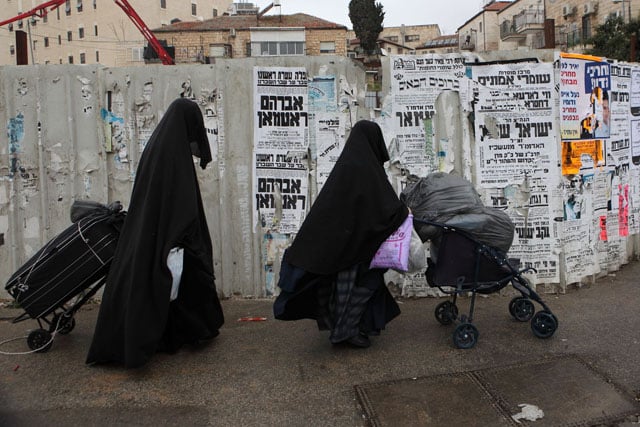 Extreme orthodox Jewish women wearing coverings from head to toe to keep their modesty and not attract men sexually.