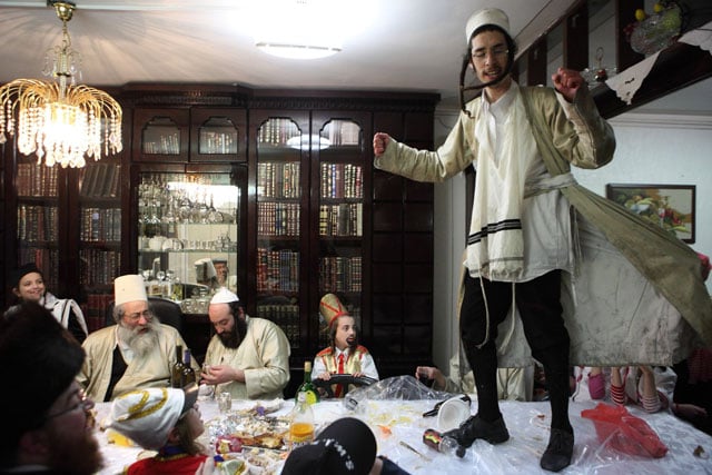 Hasidic Jews dancing at a table called 'Tish' at the Jewish holiday Purim.