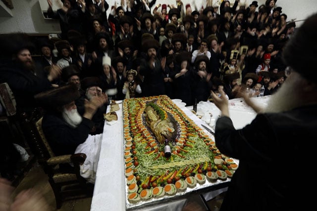 Singing and praying before eating a prepared fish.