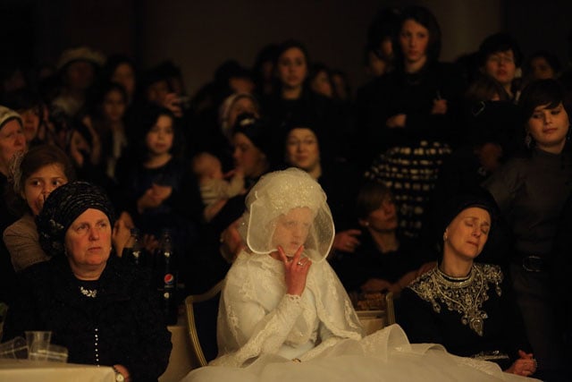 Bride waiting for the moment when an ultra-Orthodox rabbi dances with her at her wedding. The bride is covered to preserve modesty and separation between men and women.