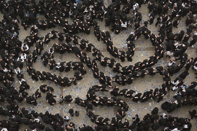 Orthodox Jews dancing at a demonstration in Jerusalem against the government's intention to force the Israeli army to recruit them.