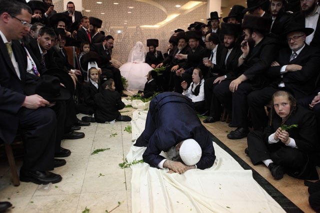 Rabbi Gamliel Rabinowitz's granddaughter before her wedding. He holds her and dances in front by a rope to keep modesty and preventing touch between man and woman, which is prohibited by the Torah.