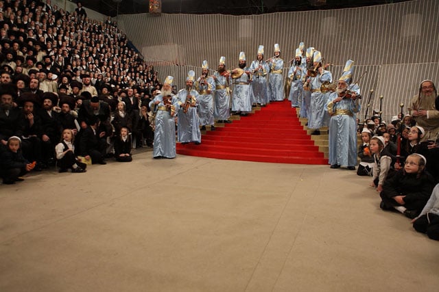 Hasidic Jews perform a show called pouring water at a temple. This is the wedding of the daughter of their master Rebbe.