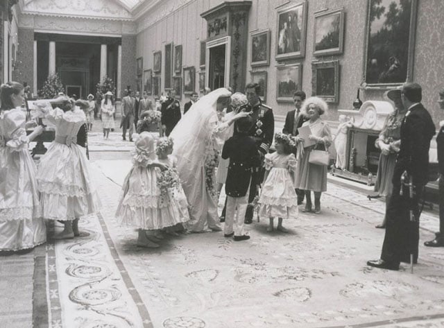 Princess Diana wearing her gorgeous wedding dress with members of her family and wedding party, including Queen Elizabeth, Prince Charles, Princess Anne, Princess Margaret, and Prince Andrew.