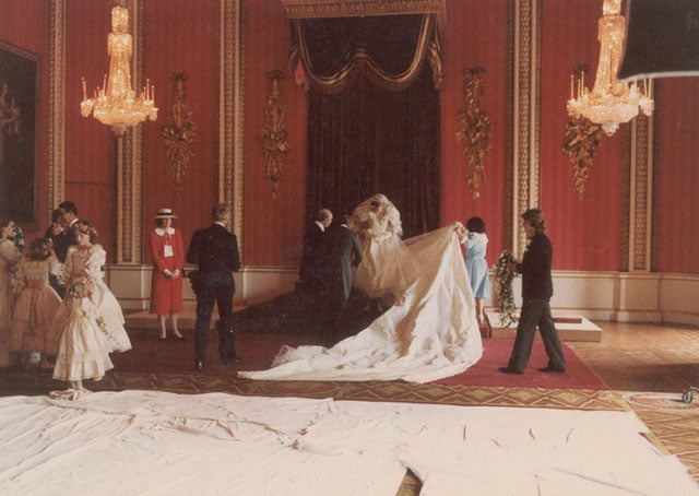 Princess Diana in the Throne Room as her dress designers Elizabeth and David Emanuel arrange the train in preparation for the formal photographs.