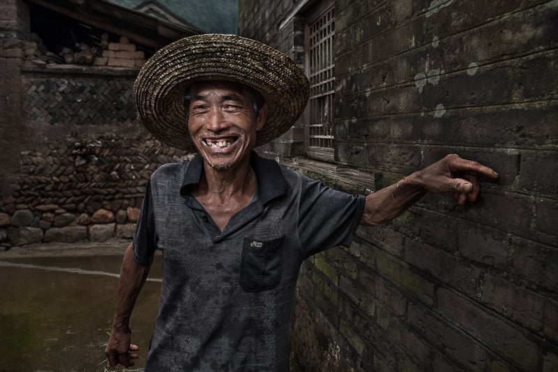 Portrait of a Chinese villager from outside Xing'Ping stopping to talk along the way.