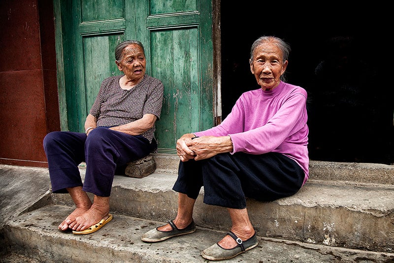 Older Chinese women sitting on the stairs