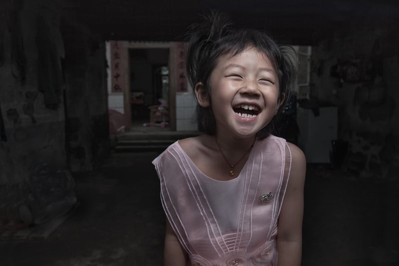 A young Chinese girl enjoying getting her picture taken.