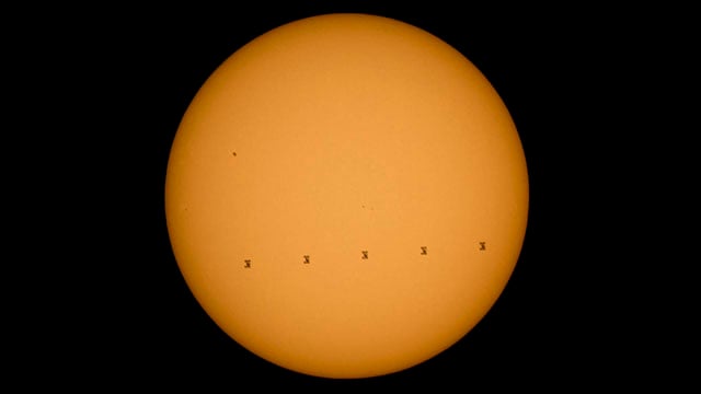 This composite image made from five frames shows the International Space Station, with a crew of nine onboard, in silhouette as it transits the sun at roughly five miles per second, Sunday, Sept. 6, 2015, Shenandoah National Park, Front Royal, VA.  Onboard are; NASA astronauts Scott Kelly and Kjell Lindgren: Russian Cosmonauts Gennady Padalka, Mikhail Kornienko, Oleg Kononenko, Sergey Volkov, Japanese astronaut Kimiya Yui, Danish Astronaut Andreas Mogensen, and Kazakhstan Cosmonaut Aidyn Aimbetov. Photo Credit: (NASA/Bill Ingalls)