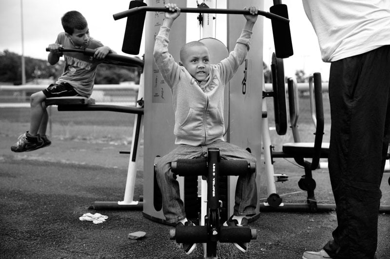 Young boy works the weights at Hooke Boxing. Patricia Goldschmid/Photographers for Hope