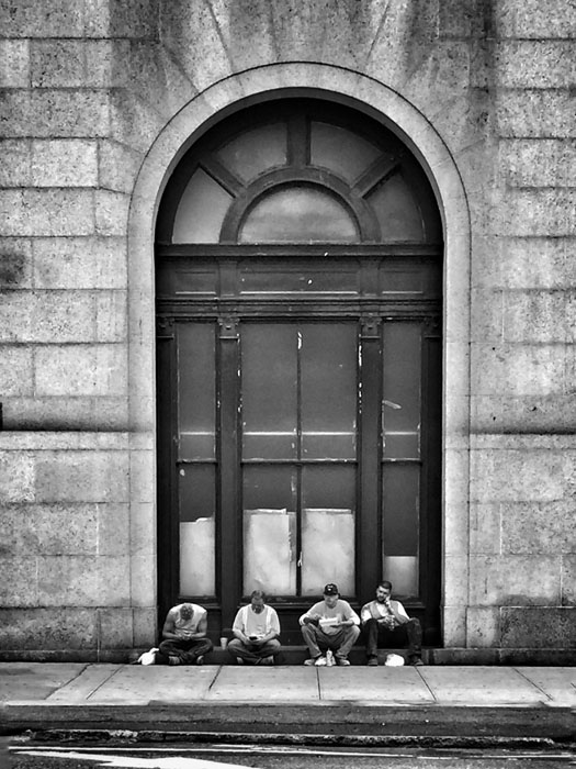 I saw this composition across the street and waited about 3 minutes for the traffic to clear. Look close, they are all on their phones! I corrected the perspective in Snapseed to make the lines all straight. 