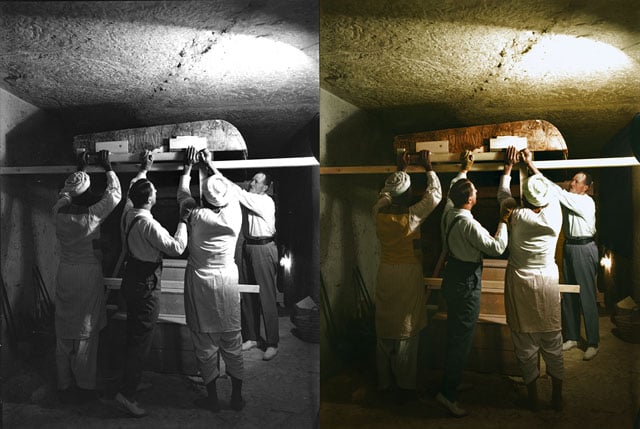 Carter, Callender and two Egyptian workers carefully dismantle one of the golden shrines within the burial chamber.