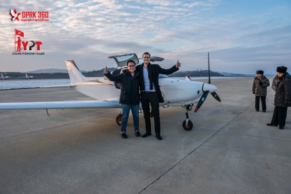 Pan (left) outside the light airplane he rode.