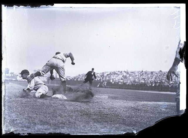 This is the original photo of Ty Cobb stealing third, sliding into Jimmy Austin. Captured by Charles M. Conlon, it's the cropped version above that became an iconic baseball photo.