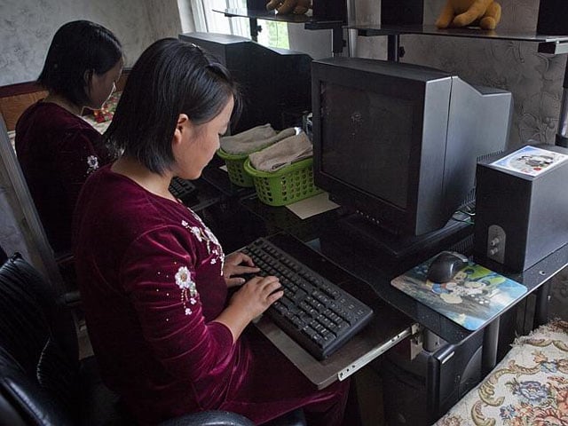 Children in a household posing in front of their computers... while there is no power.