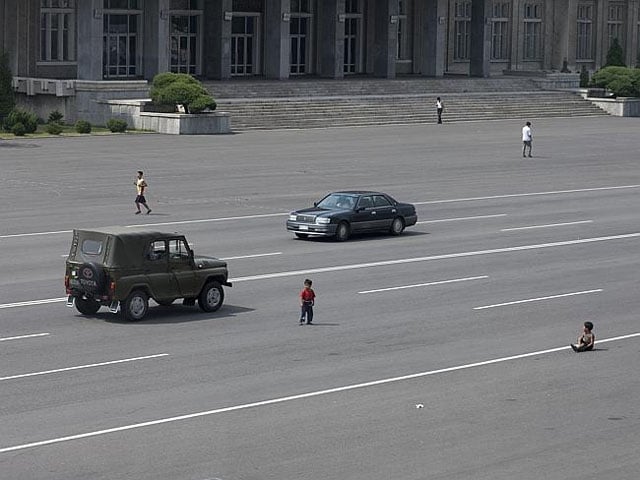 Children playing in the middle of a major road.