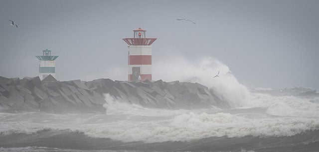 Waves hitting the pier. Later when working there I would be fully submerged in giant waves spilling over all the way past the lighthouse stucture.