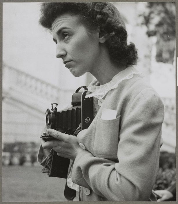 Arlington Cemetery, Arlington, Virginia. A girl taking a picture of the ceremony of laying a wreath on the Tomb of the Unknown Soldier. Photo by Esther Bubley.