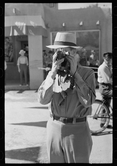 Tourist using candid camera, Taos, New Mexico. Photo by Russell Lee.